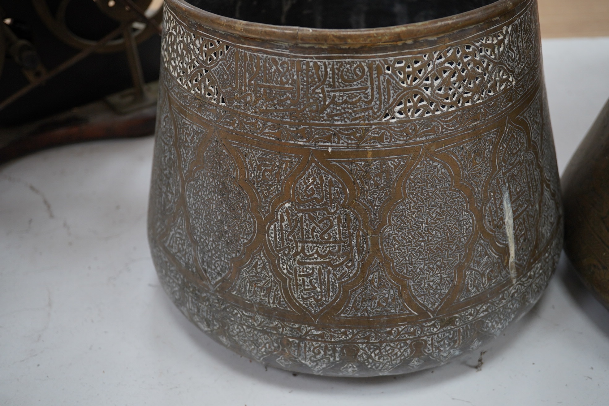 Two Benares engraved brass jardinieres, one with a pierced panels near the rim, 25cm high. Condition - fair